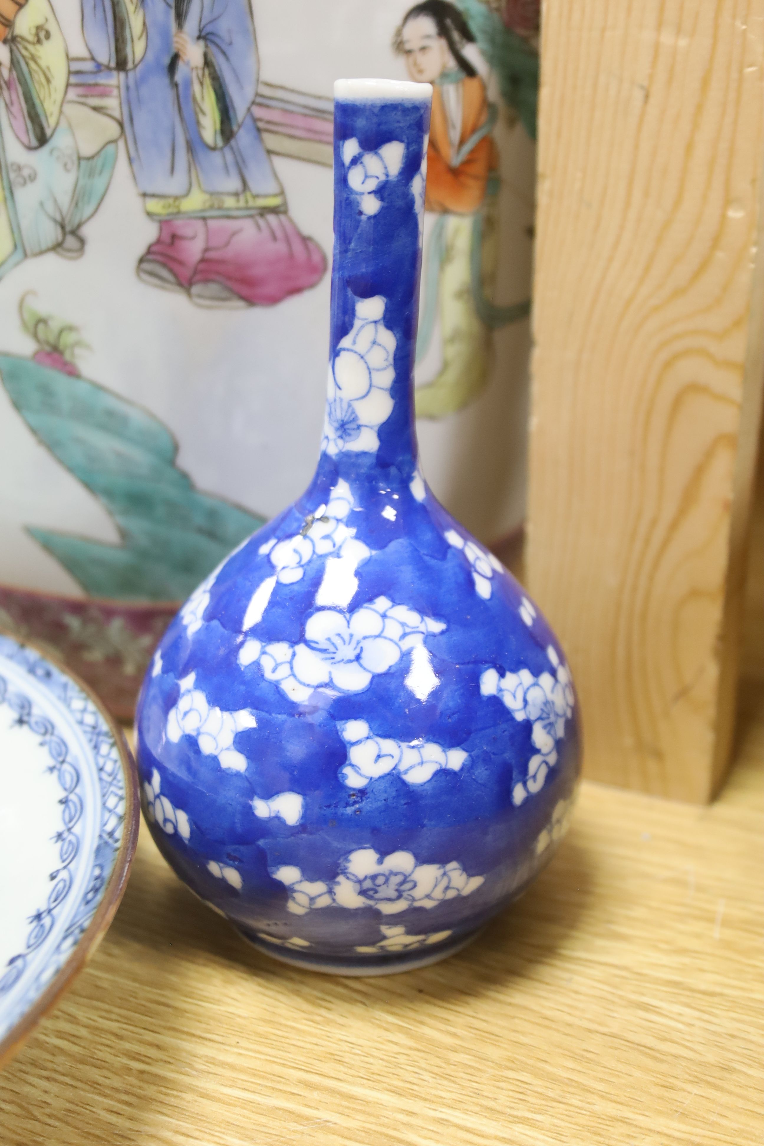 A Chinese blue and white dish, a bottle vase and jar, together with a famille rose jar lacking cover, height 29cm